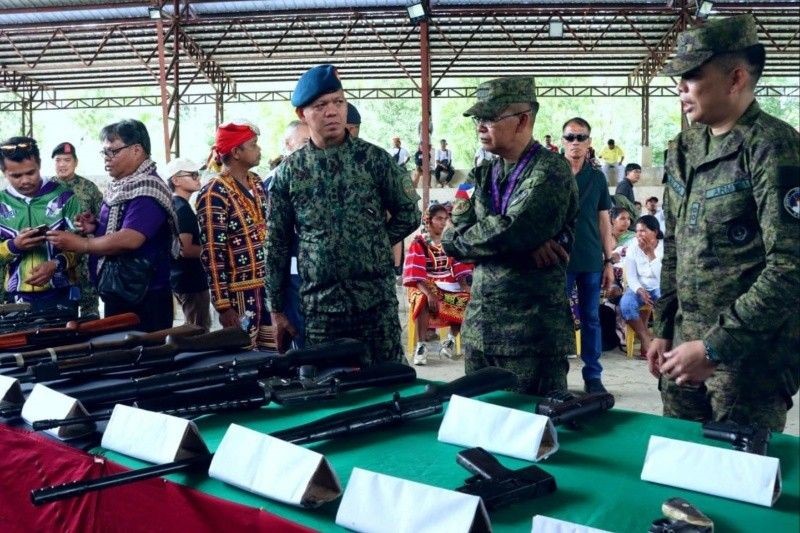 The 87 members of the New People's Army who surrendered to the 10th Infantry Division through the 89th Infantry Battalion first turned over their firearms before renouncing their membership with the group during a surrender ceremony in San Fernando, Bukidnon on Jan. 24, 2025. Photo courtesy of Philstar.com / John Unson